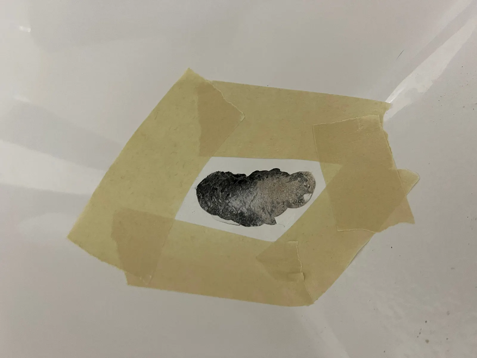 Cracked fiberglass bathtub taped off for structural repair before BathMasters refinishing on the Gulf Coast