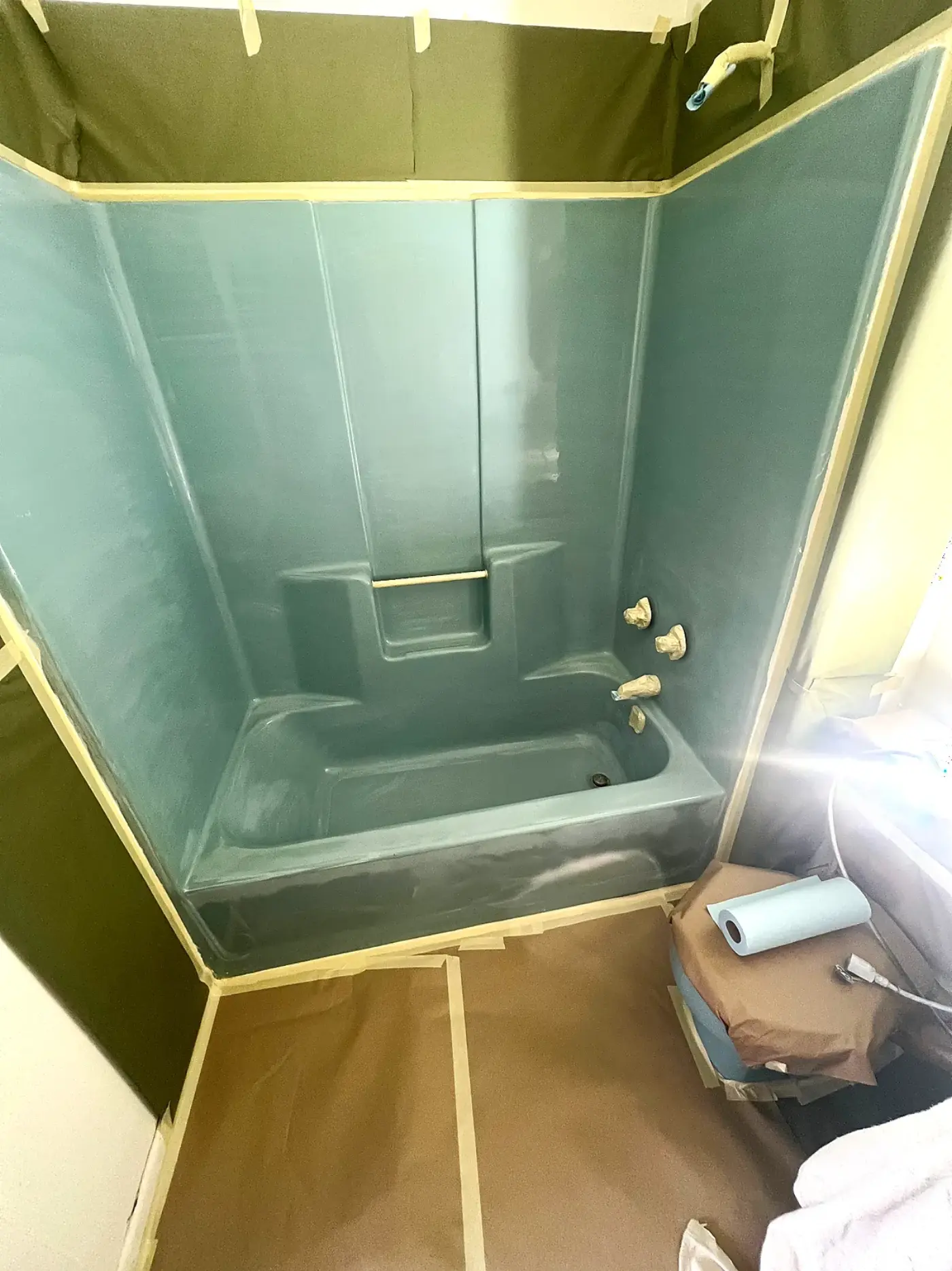 Dated teal fiberglass tub and shower surround before BathMasters refinishing on the Gulf Coast
