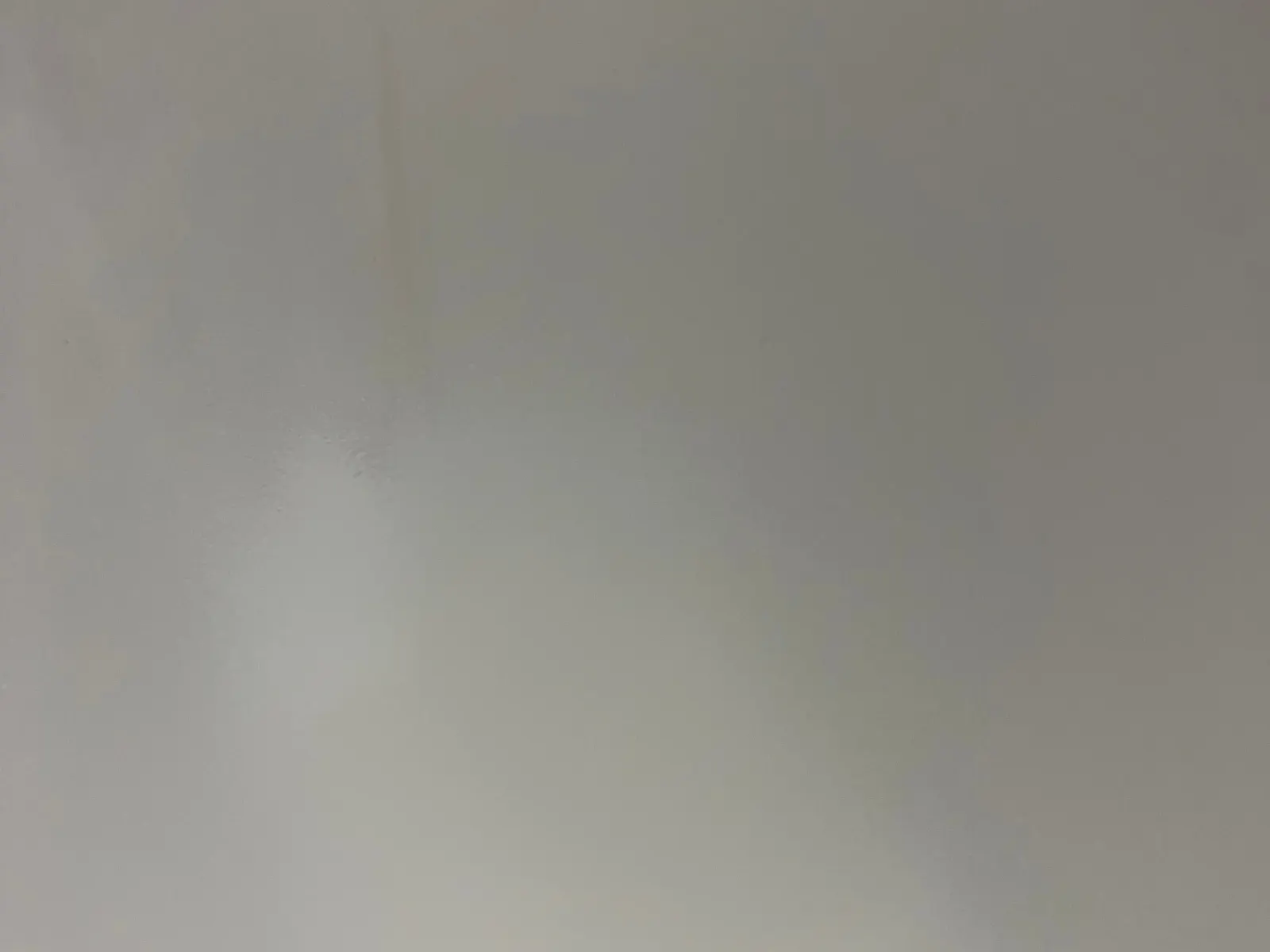 Same fiberglass bathtub area after BathMasters structural repair and refinish, smooth white surface