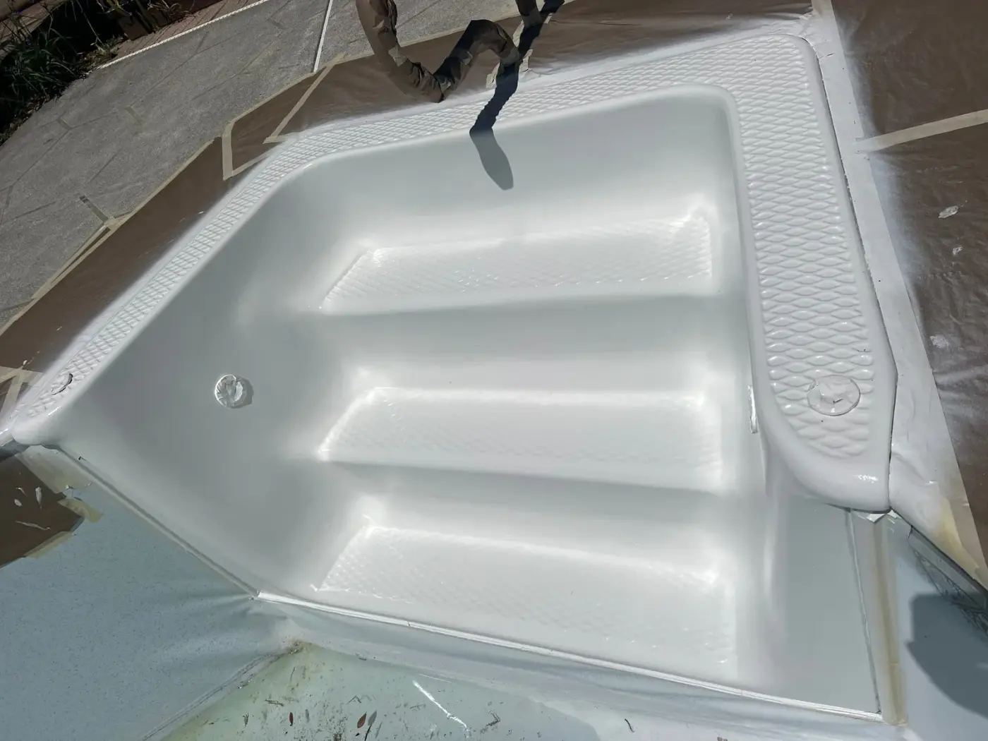 Same fiberglass pool steps after BathMasters refinishing on the Gulf Coast, smooth restored finish